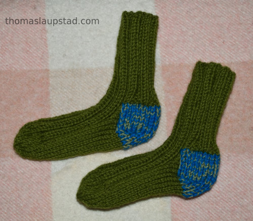 Knitted green baby socks